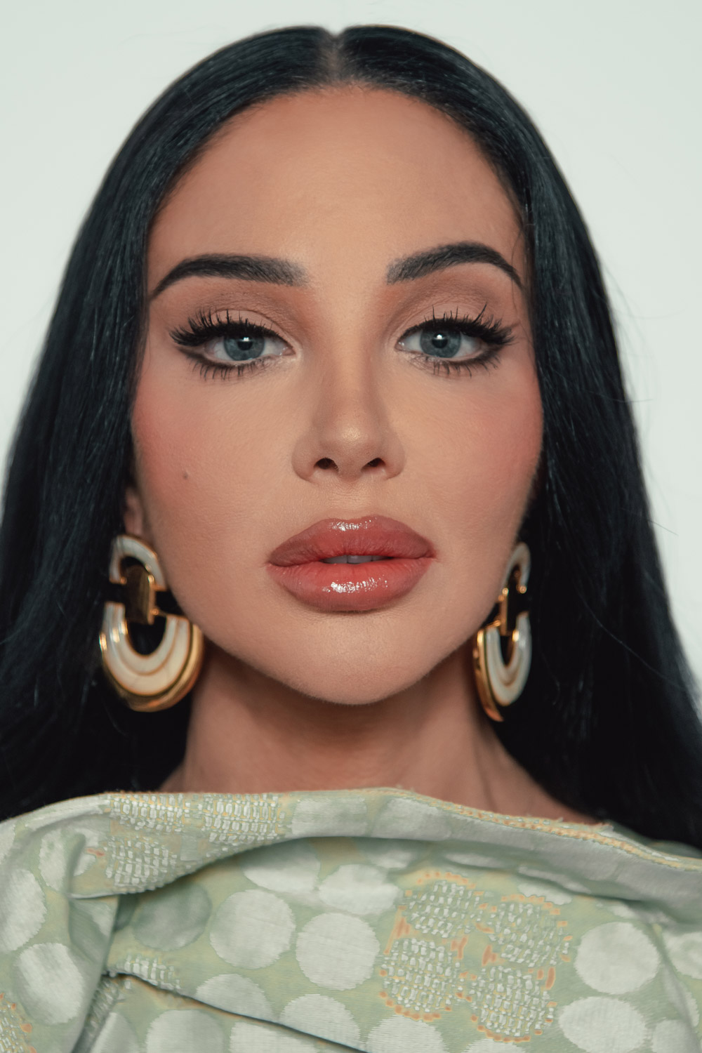 Portrait of Tulisa Contostavlos, blending elegance with a raw, fearless expression for FAULT Magazine.
